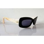 A pair of Chanel black-framed sunglasses with beige/pink quilted arms, original case, outer box and