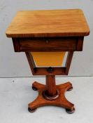 An early Victorian mahogany ladies work table with single drawer on an octagonal support and platfor
