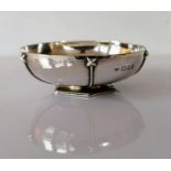 An Art Deco silver bowl with a planished, stylized design on an hexagonal base