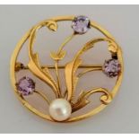 An Edwardian circular brooch with amethyst and pearl decoration, 33mm, unmarked