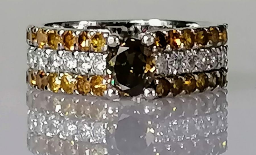 A diamond ring, the central yellowish brown diamond measuring an estimated 5.93 x 5 x 3.2mm,