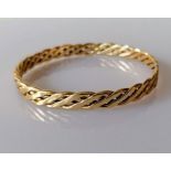 A 9ct gold bangle with woven design, 7 cm, hallmarked, 31g