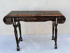 A 19th century Chinese hardwood altar table with ornately carved apron on both sides depicting drago
