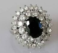 A sapphire and diamond ring, the central oval-cut sapphire 8.79 x 6.86 x 4mm, weighing a calculated