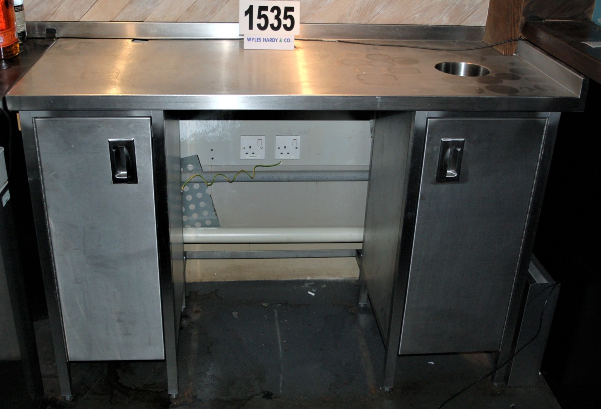 A Free Standing Stainless Steel Prep Table with Fitted Single Door Storage Cabinet to One End and