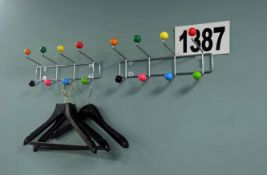 2: Chromed Steel Wall Mounted Coat Hangers Having Brightly Coloured Knobs on.