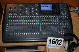 A BEHRINGER X 32 Digital Programmable Mixing Desk with a Set of Headphones