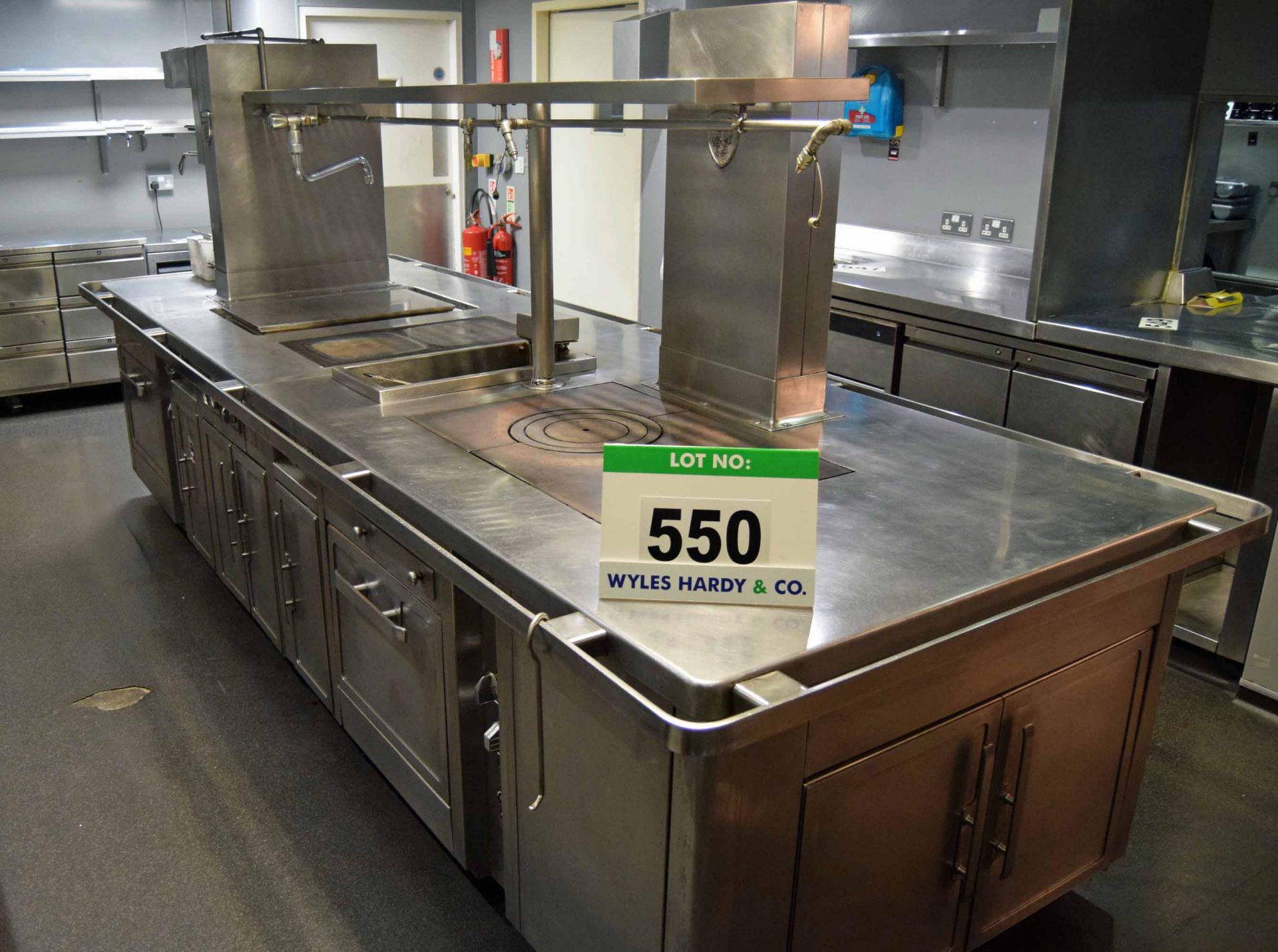 A CHARVET 3840mm x 1350mm Gas Fired Commercial Island Cooking Unit with fitted Two Single Door