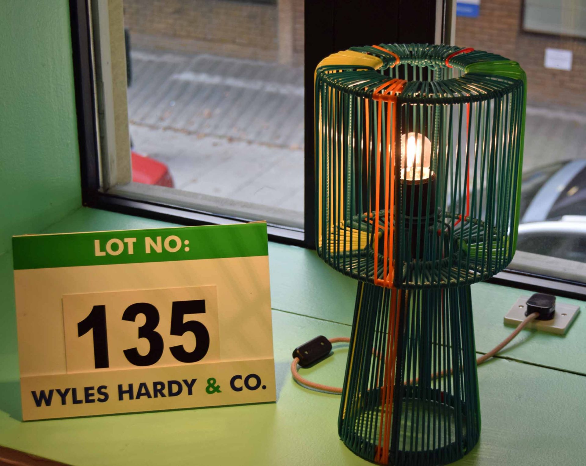 A Green/Blue/Orange/Yellow Table Lamp formed of Plastic Cord Over a Steel Frame