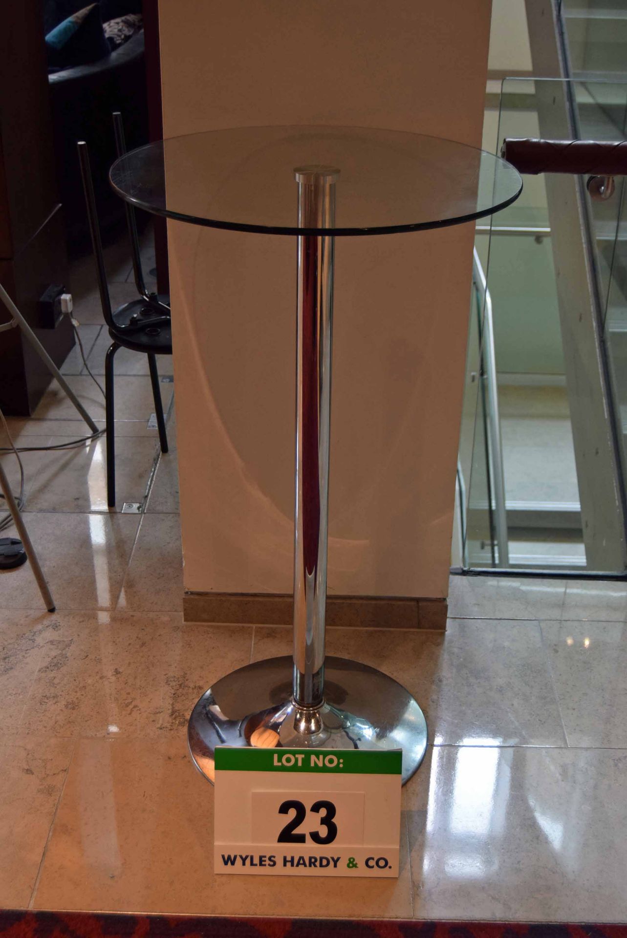 A 600mm dia. Glass Topped Circular Pedestal Table on Chromed Steel Pedestal Base