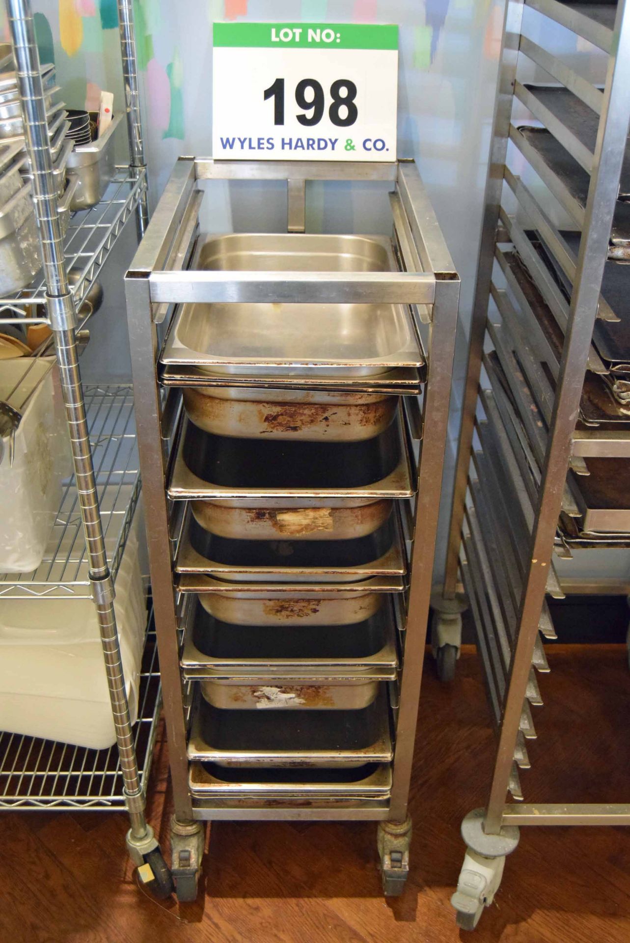 A Stainless Steel Castor mounted 11-Tier Brat Pan Trolley with A Quantity of Brat Pans and Cake