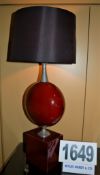 A Red Ceramic Block and Lozenge Table Lap with Brass Fittings and a Black Fabric Drum Shade