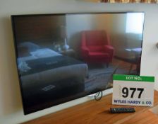 An LG 42UB830V 42 inch Smart Television on a Rigid Wall Bracket with Hand Held Remote Control