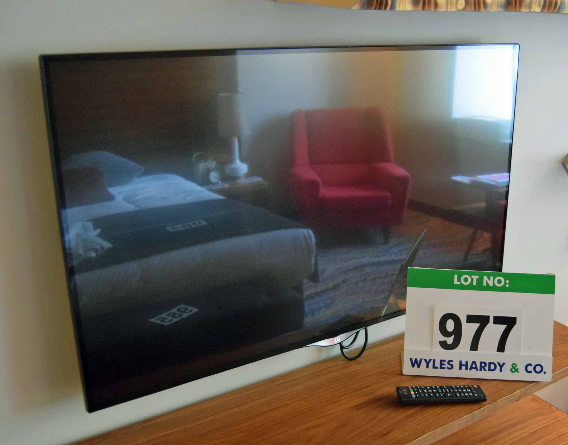 An LG 42UB830V 42 inch Smart Television on a Rigid Wall Bracket with Hand Held Remote Control