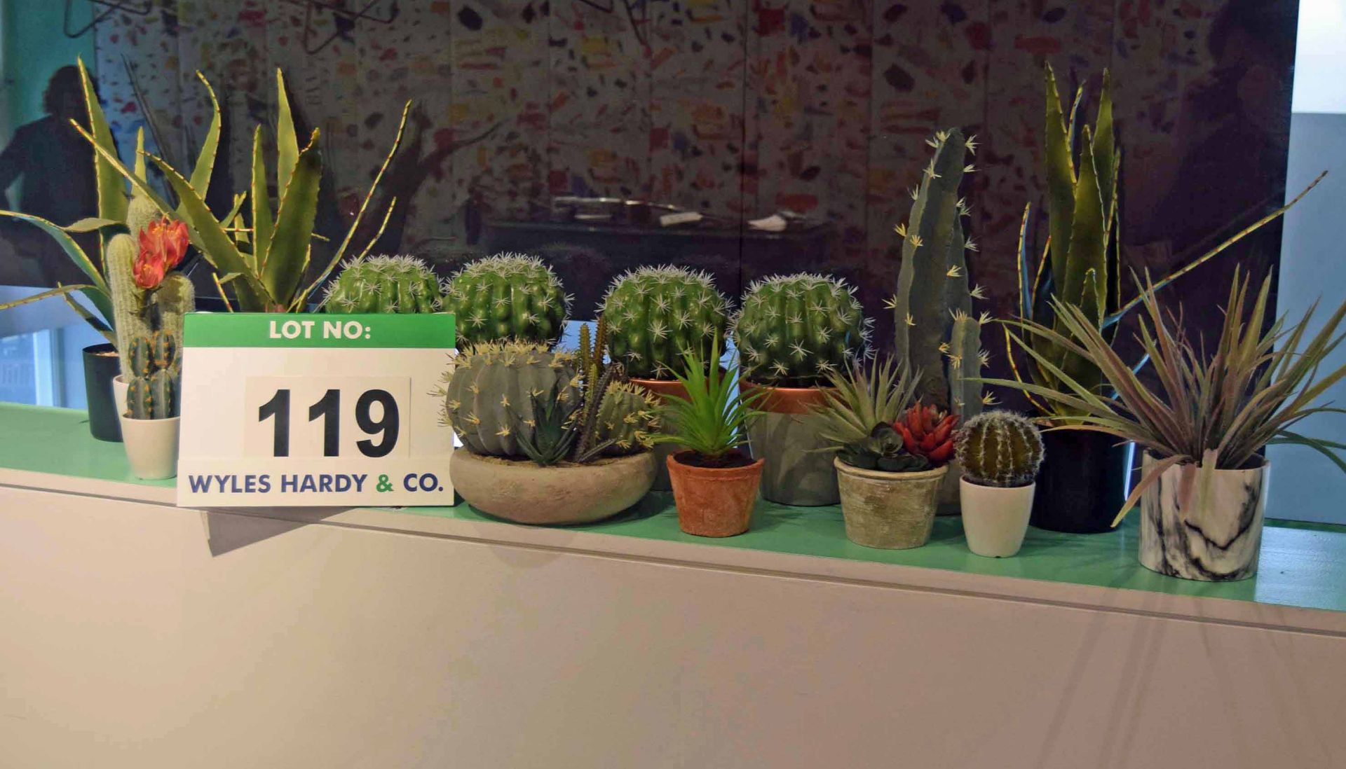 A Collection of Sixteen Artificial Cacti in Pots