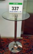 A Circular Glass Topped Pedestal Table on a Polished Stainless Steel Pedestal Base - 600mm dia. Top