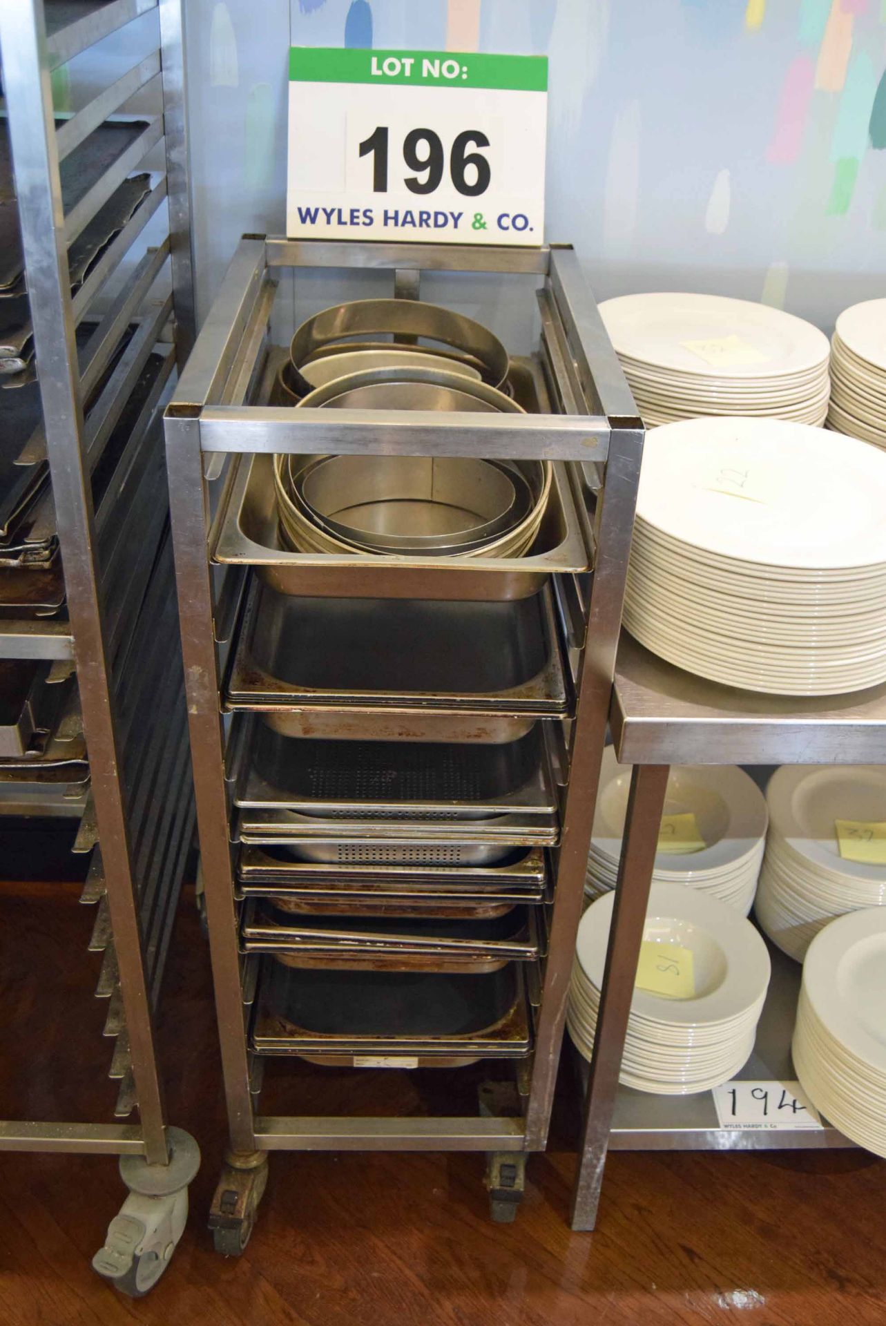 A Stainless Steel Castor mounted 11-Tier Brat Pan Trolley with A Quantity of Brat Pans and Cake