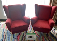 A Pair of Red Fabric Upholstered Wing Back Armchairs on Turned Black Painted Tapered Timber Legs