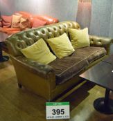 A Brown Buttoned Leather Upholstered Chesterfield Style 2-Seater Settee on Turned Wooden Legs with