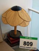 A Table Lamp with Wooden Base, Bamboo Stem and Palm Leaf Dome Shade with Steel Cap