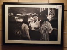 A Framed and Glazed Black and White Photographic Print Depicting a Conversation Between Associated