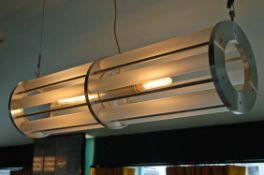 A Tube Form Twin Bulb Suspended Ceiling Light Having Turned Alloy Centre and End Plates with