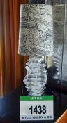 A Multi Tiered Perspex Table Lamp with Cream Coloured Fabric Shade Having Black Sketchings Depicting