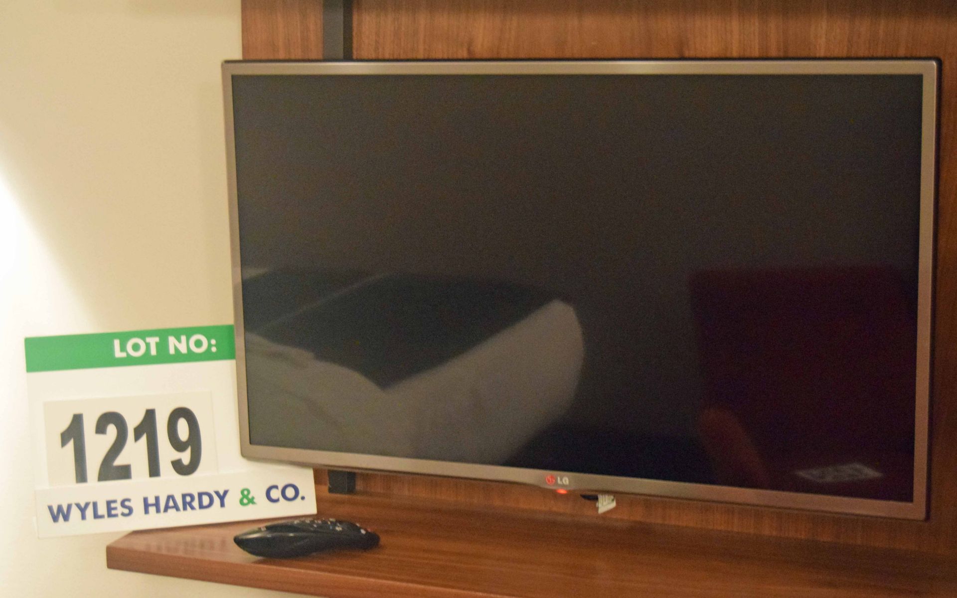 An LG Model 32UB650V Smart Television on a Fixed Wall Bracket with Hand Held Remote Control