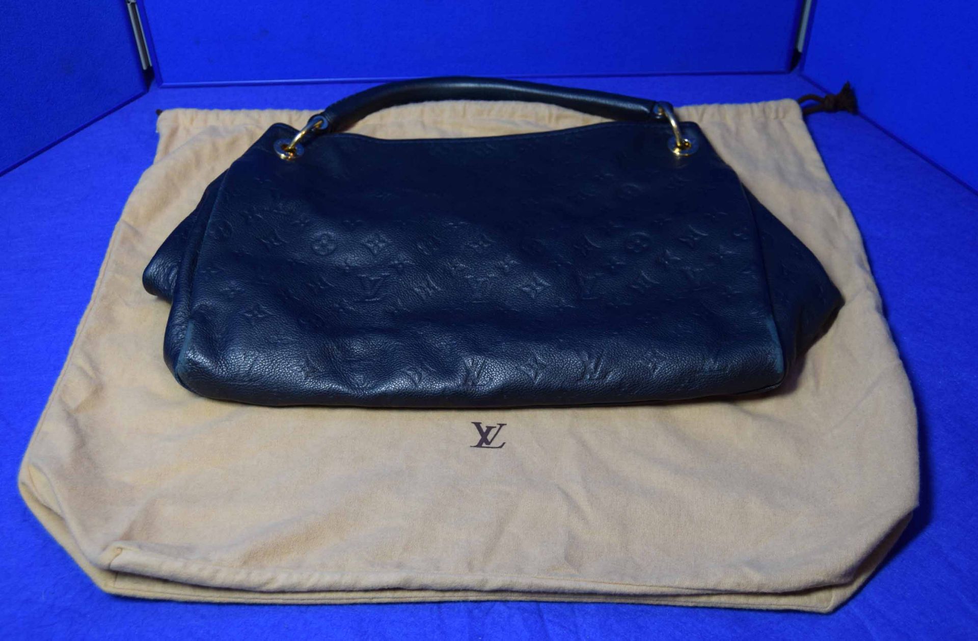 A LOUIS VUITTON Artsy Tote Bag in Navy Blue Imprinted Leather with embossed Logos. The open top