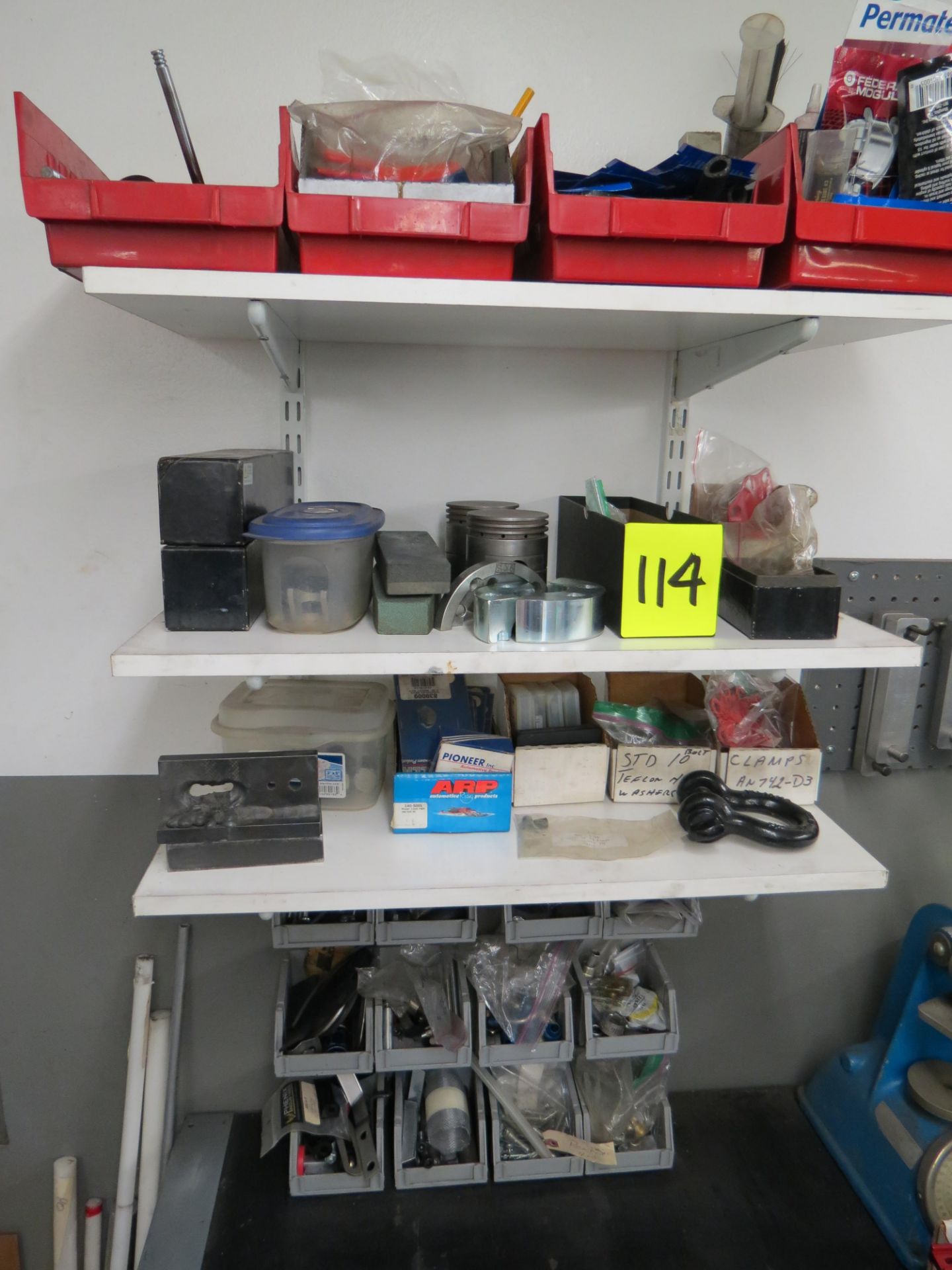 LOT OF ASSORTED PARTS, CLAMPS, ADHESIVES , BOLTS, ON WALL AND BELOW BENCH (2) SHELVES