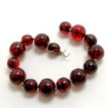 Short strand of reconstituted red amber beads - 29cm long - no clasp