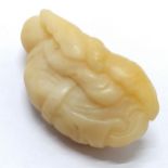 Antique Chinese white jade pebble carving of an Immortal clasping a fruit - 8cm long