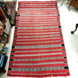 Middle Eastern (Iranian?) red grounded wool rug - 232cm x 130cm & has some fading
