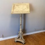 Floor standing carved wooden lectern with a cream paint finish 122cm high, in good used condition.