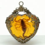 Amber coloured heart shaped scorpion pendant in a white metal mount - 5.5cm drop
