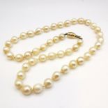 Strand of pearls with 9ct marked gold clasp by J Köhle - 44cm long