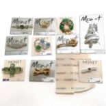 10 Monet brooches on their original selling cards including a Christmas tree 7cm long Condition