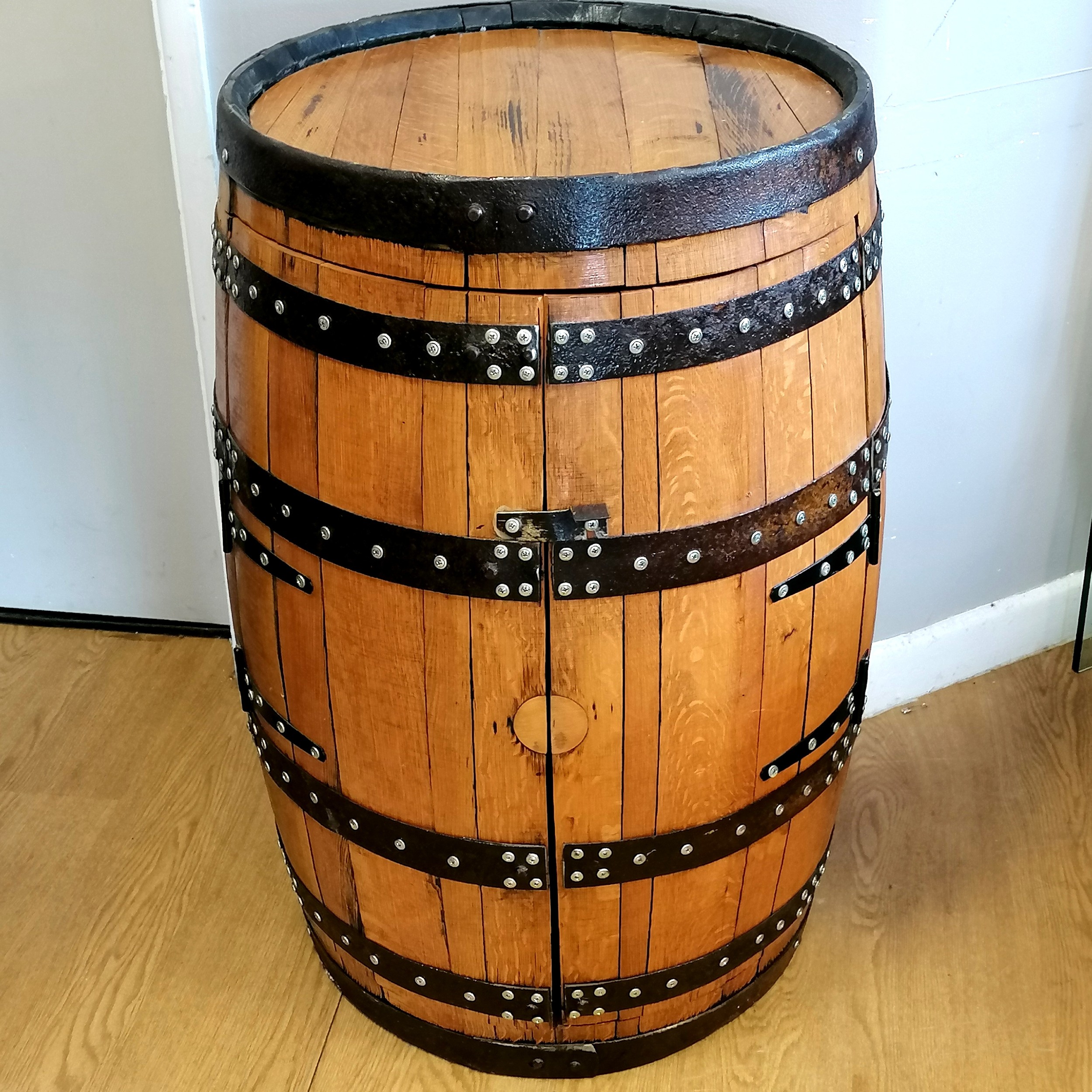 Bar/drinks cabinet converted from an oak whisky barrel with metal banding, 56cm diameter x 89cm high