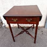 Antique mahogany drop flap side table with stretcher base and single drawer. 77cm high closed 62cm