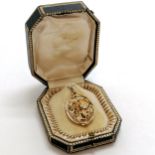 Antique gold locket with sliding plique-a-jour panel with dragon detail which is set with a