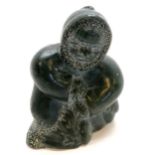 Native Canadian / Inuit carved figure of an kneeling eskimo etched with disc number 5-99012 & has