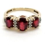 14ct marked gold red stone (3) & diamond (14 inc 8 baguettes) ring - size P & 2.6g total weight