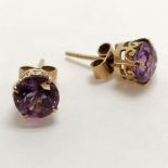 9ct marked gold pair of amethyst earrings - approx 7mm in diameter & 1.6g total weight