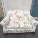 Antique 2 seater sofa/ settee with floral upholstery and carved wooden paw feet. 80cm high x 136cm