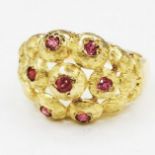18ct marked (indistinct) gold ring set with 7 rubies - size L & 5.6g total weight