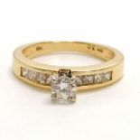 14ct (marked 14k) gold high set diamond solitaire ring with princess cut diamond set shoulders -