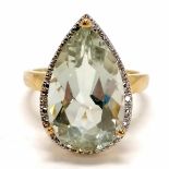 9ct hallmarked gold blue pear shaped stone ring surrounded by small diamonds - size P & 4.8g total