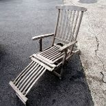 Teak and brass steamer chair with green seat cushions