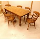 Large pine kitchen table with drawer to one end t/w six pine chairs including one carver. Table