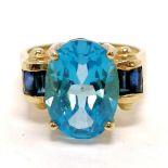 14ct marked gold ring set with blue topaz (14mm x 10mm) & 4 baguette sapphires - size N½ & 6.4g